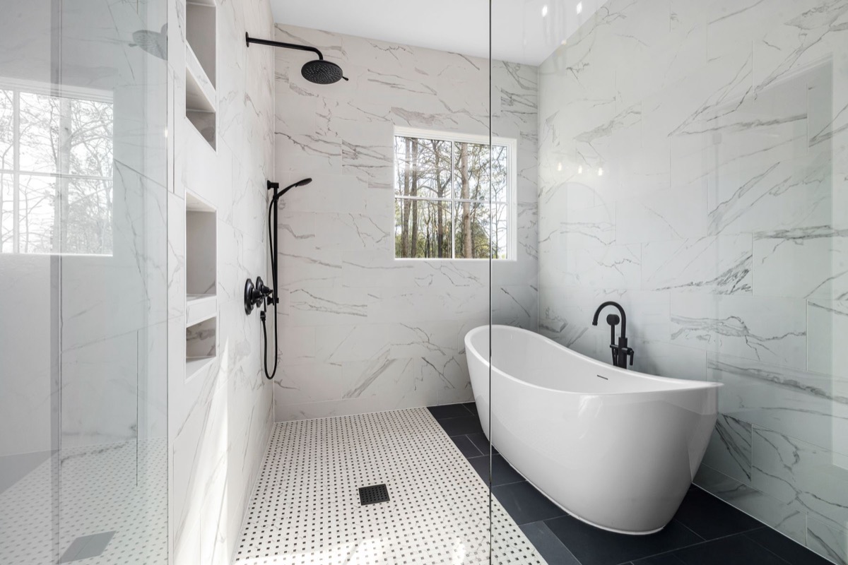 Marble primary bath with freestanding tub and glass shower