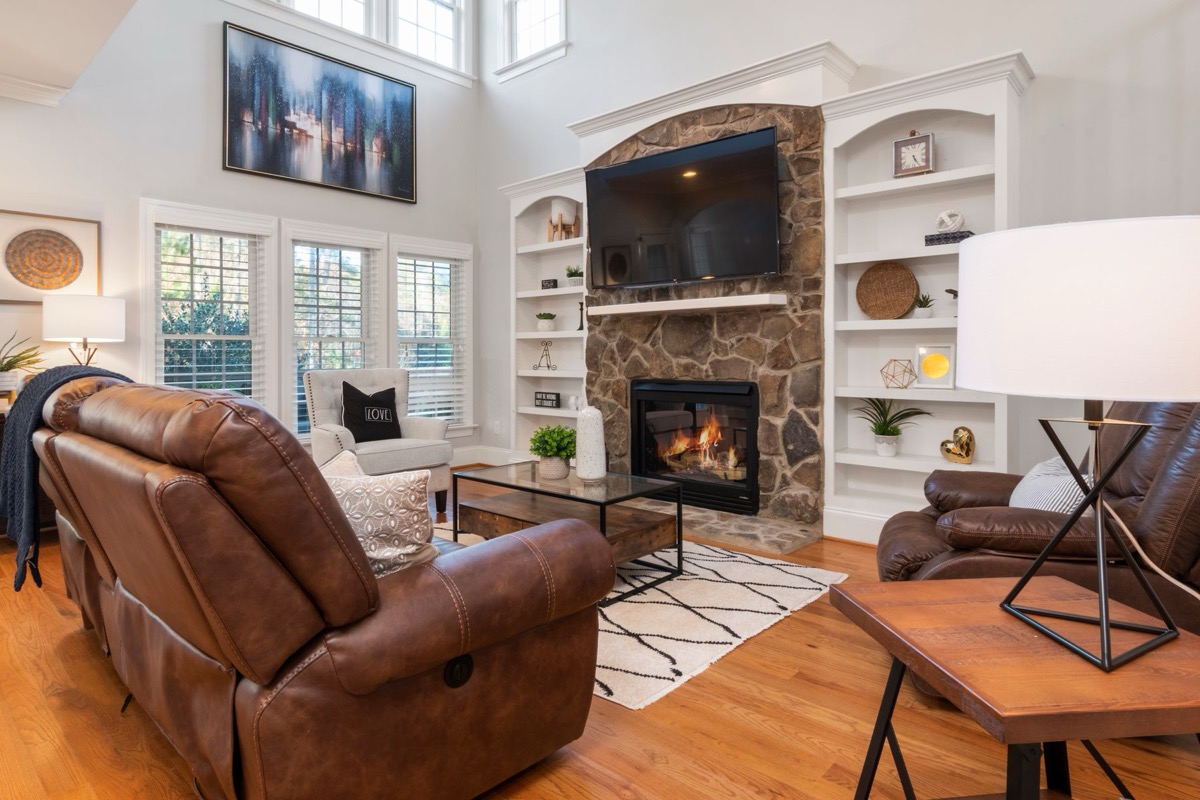 Great room with floor-to-ceiling stone fireplace and custom built-ins