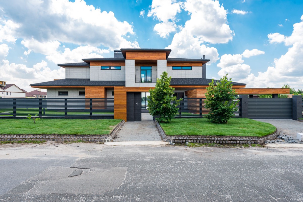 Modern custom home with cedar cladding and horizontal fencing
